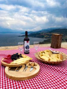 a table with a bottle of wine and plates of food at Monteverde in Tota +30 photos