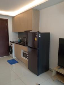 a kitchen with a black refrigerator in a room at Laguna Beach Resort 3 The Maldives in Jomtien Beach
