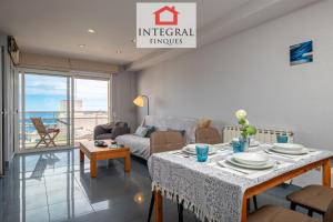 a living room with a table and a couch at Sol i Aire Apartament Palamós in Palamós