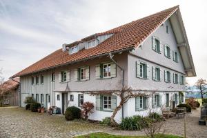 a large white house with a red roof at Windhäusern5 in Wangen im Allgäu