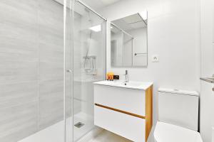 a white bathroom with a sink and a shower at Sunshine in Pilar de la Horadada +18 photos