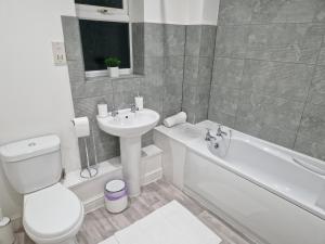 a bathroom with a toilet and a sink and a bath tub at Charming Home in Stourport Sleeps10 with Wifi&Parking by PureStay Short Lets in Stourport