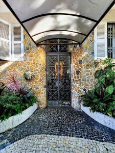 a entrance to a stone building with a door at Ipagarden in Rio de Janeiro