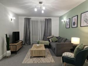 a living room with a couch and a table at Charming Home in Stourport Sleeps10 with Wifi&Parking by PureStay Short Lets in Stourport