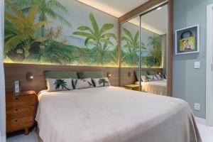 a bedroom with a large bed and a painting on the wall at Ipagarden in Rio de Janeiro