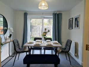 a dining room with a table and chairs and a window at Charming Home in Stourport Sleeps10 with Wifi&Parking by PureStay Short Lets in Stourport
