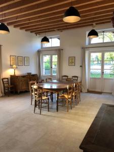 a dining room with a wooden table and chairs at Chateau de Tosny in Tosny