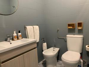 a bathroom with a toilet and a sink at House in the Town Centre in Caminha +51 photos