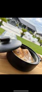 a frying pan with a piece of bread in it at Green Garden in Suceava