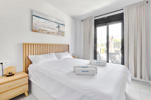 a bedroom with a bed with two trays on it at Sunshine in Pilar de la Horadada