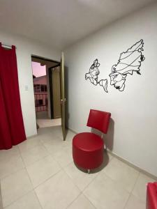 una silla roja en una habitación con pared en Apto caney 402, en Cali