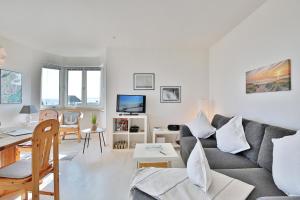 a living room with a couch and a table at Strandschlößchen Strandschlösschen Appartement 5 in Haffkrug
