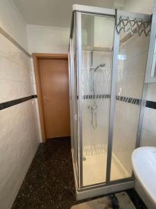 a glass shower in a bathroom with a sink at Gästehaus Victoria in Cölbe