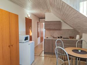 a small kitchen with a table and a microwave at Ubytovanie LISKA in Radava