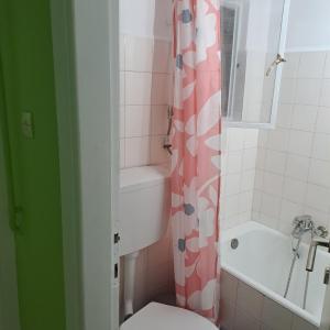 a bathroom with a toilet and a shower curtain at KENTRO PATRA 3 in Patra