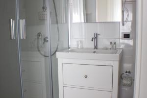 a white bathroom with a sink and a shower at Il Piccolo Eden in Pontinia +28 photos