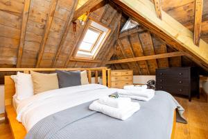 a bedroom with a large bed with towels on it at Unique Detached House wPrivate Courtyard, London in London