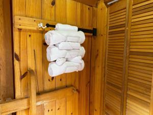 a bunch of towels are hanging on a wall at Homely Poolside Cabin in Salisbury