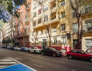 a row of cars parked in front of a building at Cozy apartment-2Bedrooms 1Bathroom-Atocha in Madrid