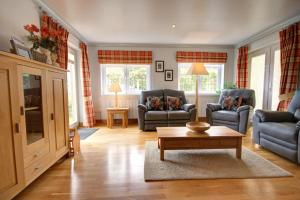 a living room with two couches and a coffee table at No1 The Links Apartment, Brora in Brora