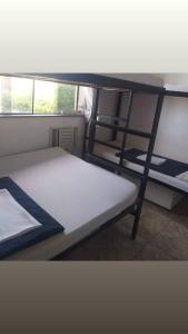 a bedroom with a bunk bed and a ladder at hostel quintal da sereia in Salvador