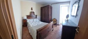 a bedroom with a bed and a dresser and a window at Casa AL TEATRO in Diano Castello