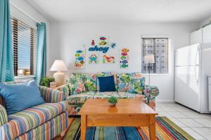 a living room with a couch and a table at Gulf Shores Plantation-East 3207 in Gulf Shores