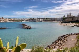 a view of a beach with people in the water at Ella Apartment in Otranto