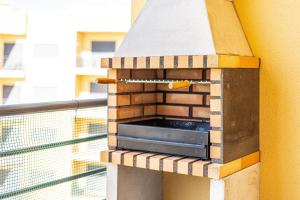 a wooden bird house sitting on top of a balcony at Mar & Serra ARMACAO DE PERA in Armação de Pêra