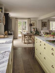 a kitchen with a table and a dining room at Plum House in Haslemere