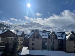 a view of a city with snow covered mountains at Apartamento CENTRO FORMIGAL in Formigal