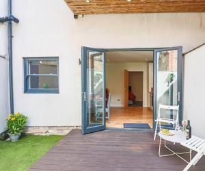 a patio with a door open to a house at Cambridge Mews in Cleethorpes