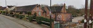 a building on the side of a street at The mill wheel in Hartshorne