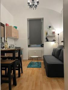 a living room with a couch and a table at Studio Gospel - Augarten Graz - 29 m² in Graz