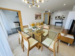a living room with a glass table and chairs at Marina Vilamoura Aquamar 320 by Vilamoura Sun in Vilamoura