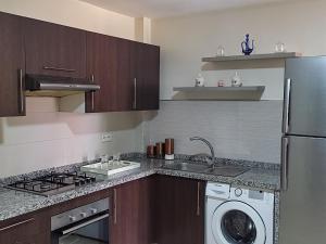 eine Küche mit Spüle, Waschmaschine und Trockner in der Unterkunft Appartement 3 in Agadir