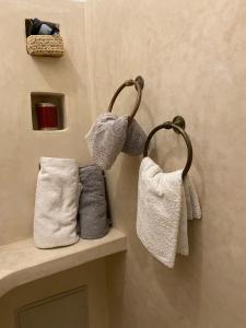 a bathroom with towels hanging on a wall at Riad Djebel in Marrakech