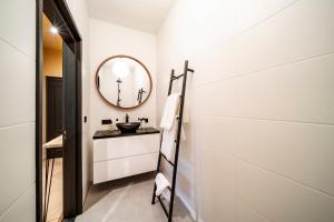 a bathroom with a sink and a mirror at Breda City Apartments in Breda