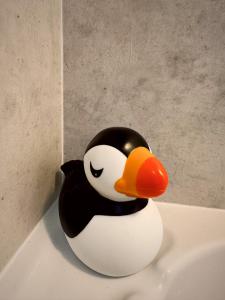 a penguin toy sitting on top of a bath tub at Firth View, Burghead in Burghead