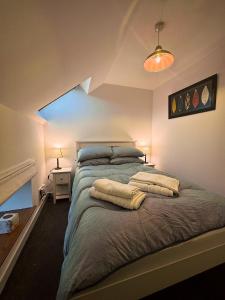 a bedroom with a large bed with two pillows on it at Firth View, Burghead in Burghead