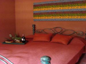 a bedroom with a bed with a red comforter at Ikweta Country Inn Maua in Kaathene +26 photos