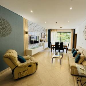 a living room with two couches and a dining room at Marina Vilamoura - Aquamar 009 - By Vilamoura Sun in Loulé