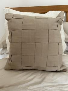 a pillow sitting on top of a bed at Stylish house centrally located in Bury Saint Edmunds