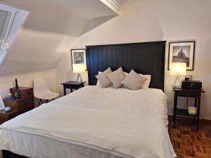 ein Schlafzimmer mit einem großen weißen Bett mit zwei Lampen in der Unterkunft Gran Piso en Viveiro con Parking Vista al mar in Viveiro