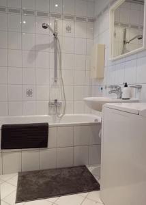 a bathroom with a shower and a tub and a sink at Wohnung mit Balkon in Fürth in Fürth
