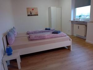 a white room with a bed and a window at Wohnung mit Balkon in Fürth in Fürth