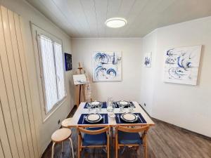 a room with a table and two chairs in it at Grand appartement Les Peintures in Thonon-les-Bains