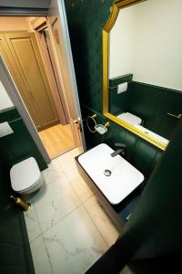 a bathroom with a white sink and a mirror at Tempus in Bucharest