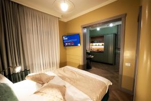 a hotel room with a bed and a television at Tempus in Bucharest