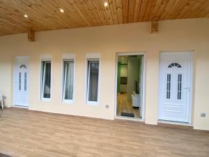 a room with white doors and a wooden ceiling at Tirana Center Apartaments in Tirana